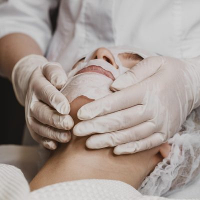 young-beautiful-woman-getting-skin-mask-treatment